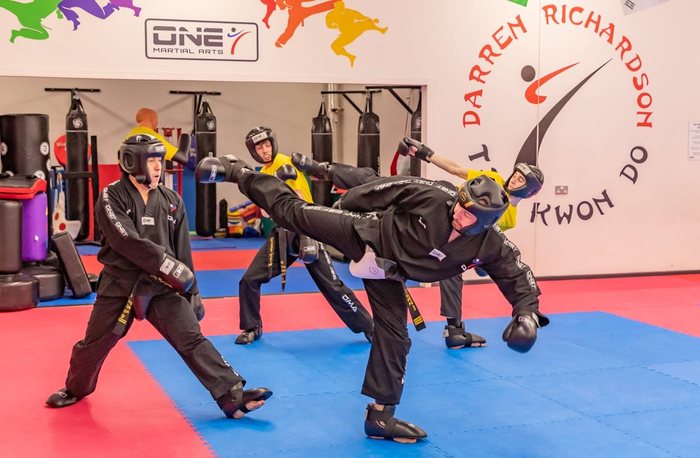 Two instructors sparring in protective gear