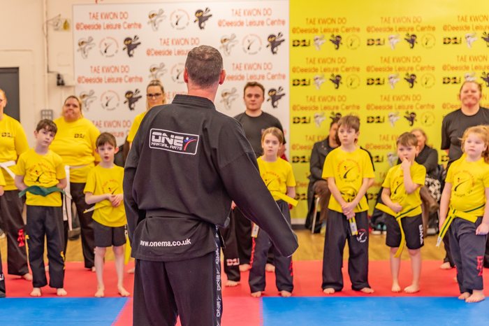 Instructor addressing students at a grading event